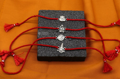 Handmade 925 sterling silver Ganesha, Sai Baba, and Tirupati idols thread rakhi bracelet by Tribal Ornaments featuring unique religious motifs.