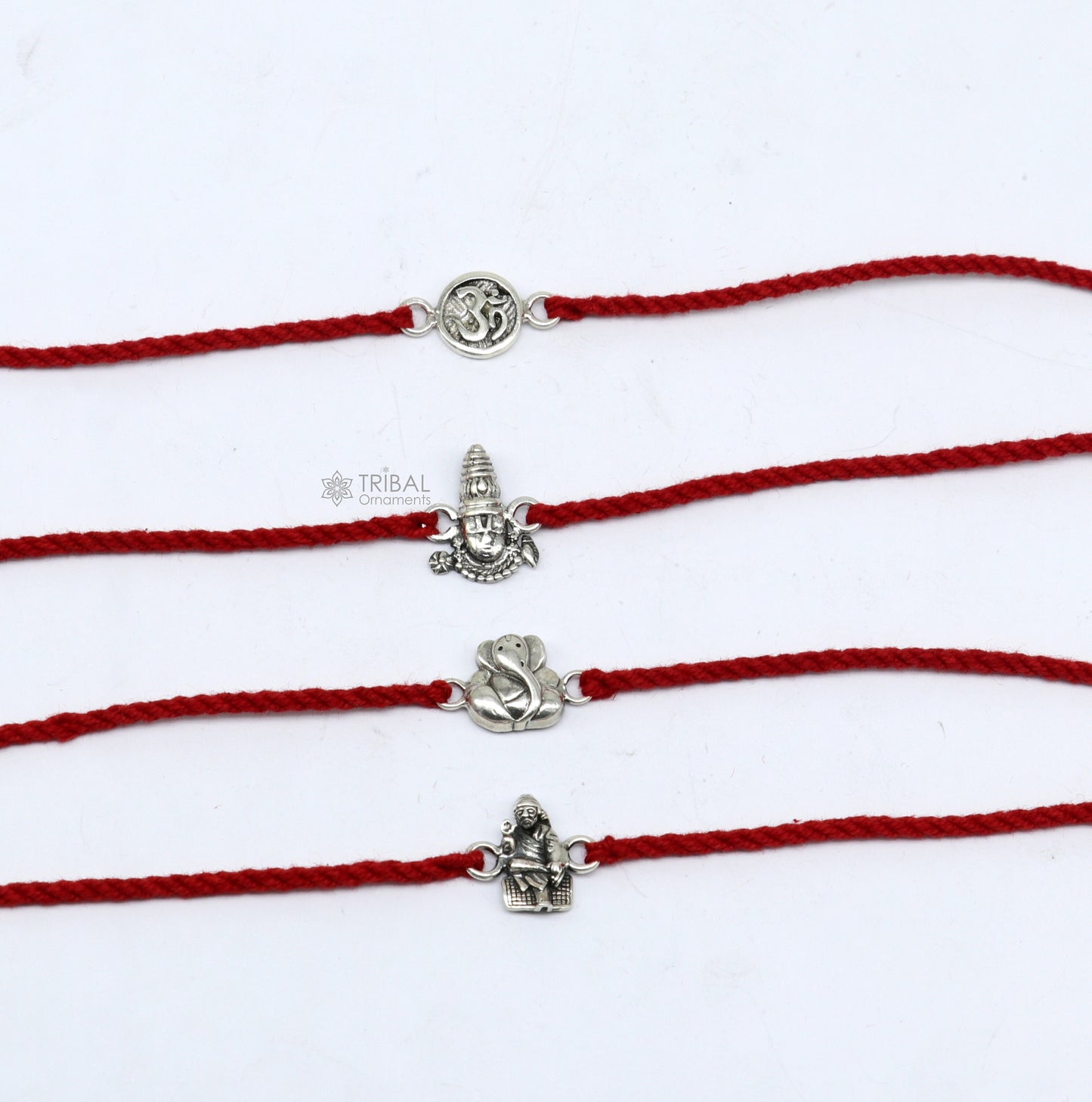 Handmade 925 sterling silver Ganesha, Sai Baba, Tirupati idols thread rakhi bracelet by TRIBAL ORNAMENTS, featuring unique divine god figures.