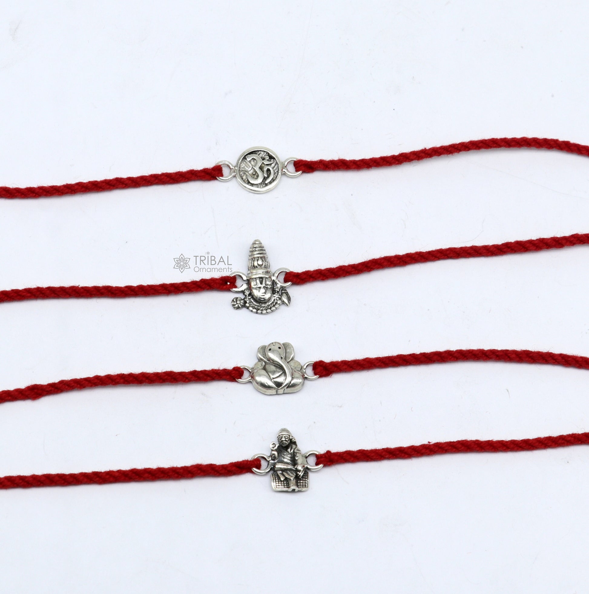 Handmade 925 sterling silver Ganesha, Sai Baba, Tirupati idols thread rakhi bracelet by TRIBAL ORNAMENTS, featuring unique divine god figures.