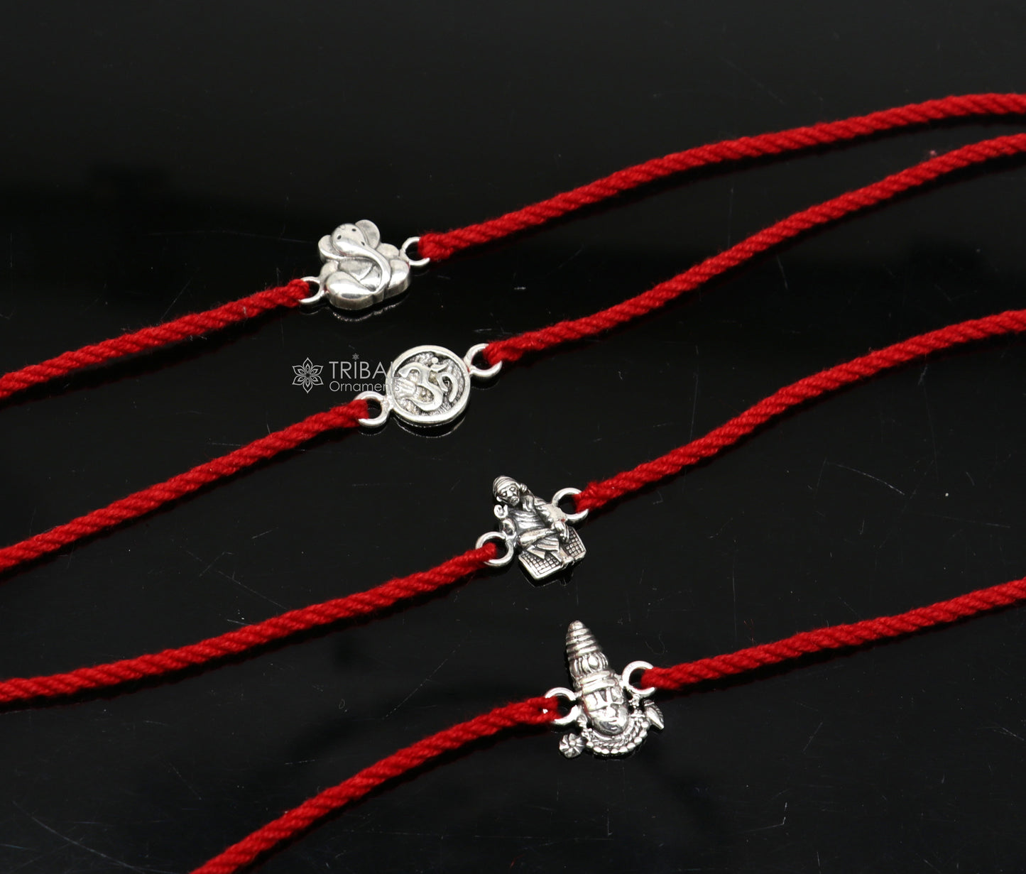 Handmade 925 sterling silver Ganesha, Sai Baba, and Tirupati idols thread rakhi bracelet by Tribal Ornaments.