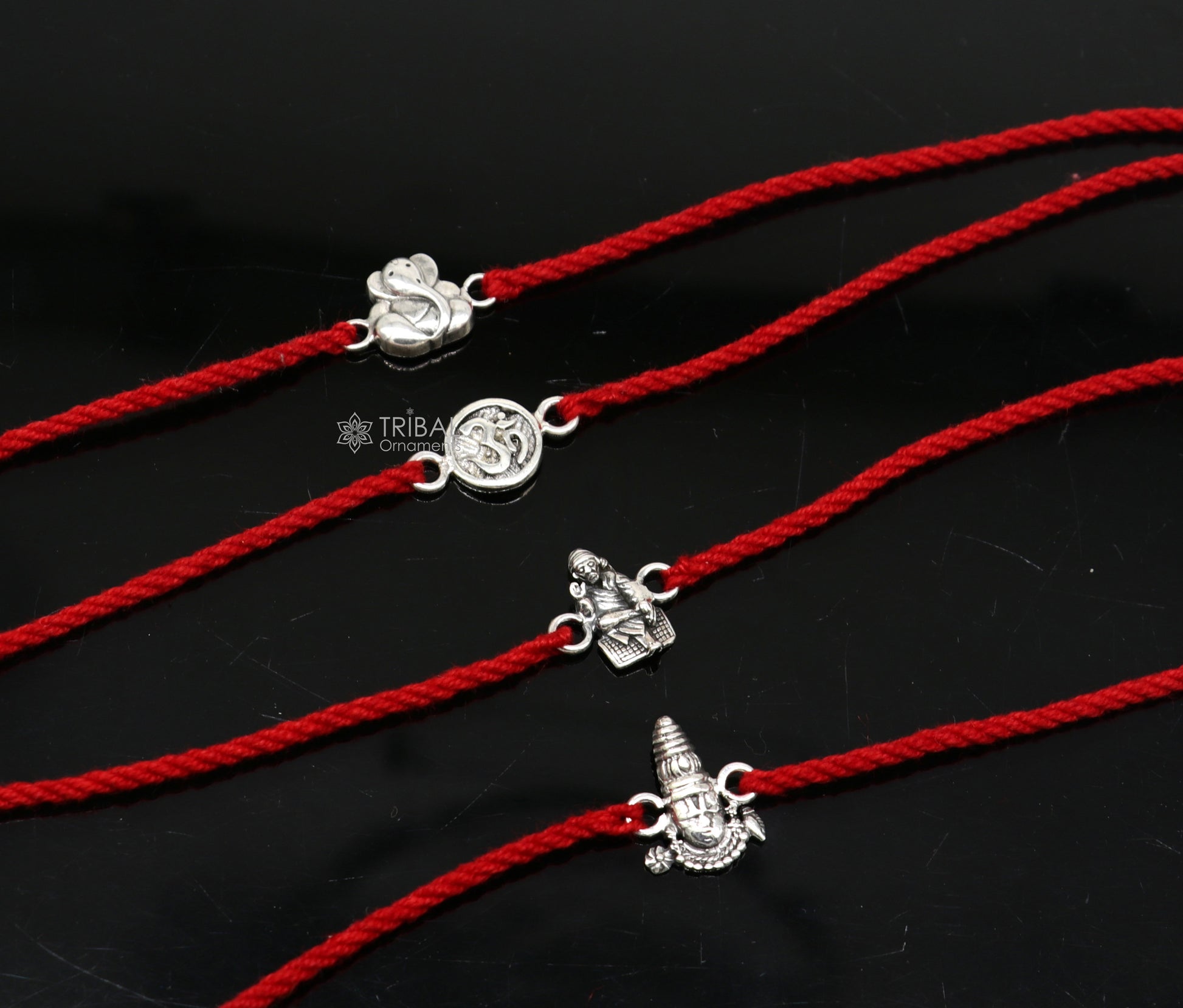 Handmade 925 sterling silver Ganesha, Sai Baba, and Tirupati idols thread rakhi bracelet by Tribal Ornaments.