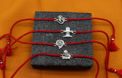 Handmade 925 sterling silver Ganesha, Shiva Lingam, Sai Baba idols on a unique thread rakhi bracelet by Tribal Ornaments.