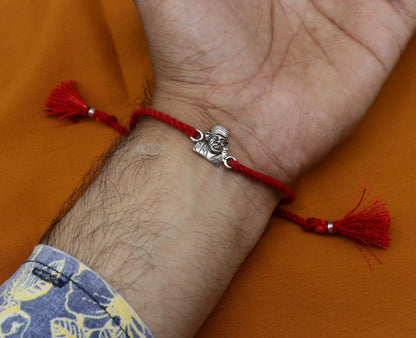 Handmade 925 sterling silver Ganesha, Shiva Lingam, Sai Baba idols and thread rakhi bracelet by TRIBAL ORNAMENTS.