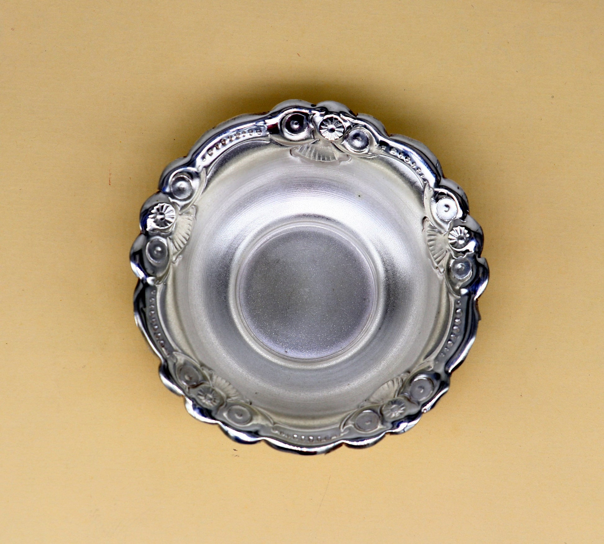 Handcrafted 999 fine silver bowl from TRIBAL ORNAMENTS, lightweight puja utensil with intricate silver work and elegant design.