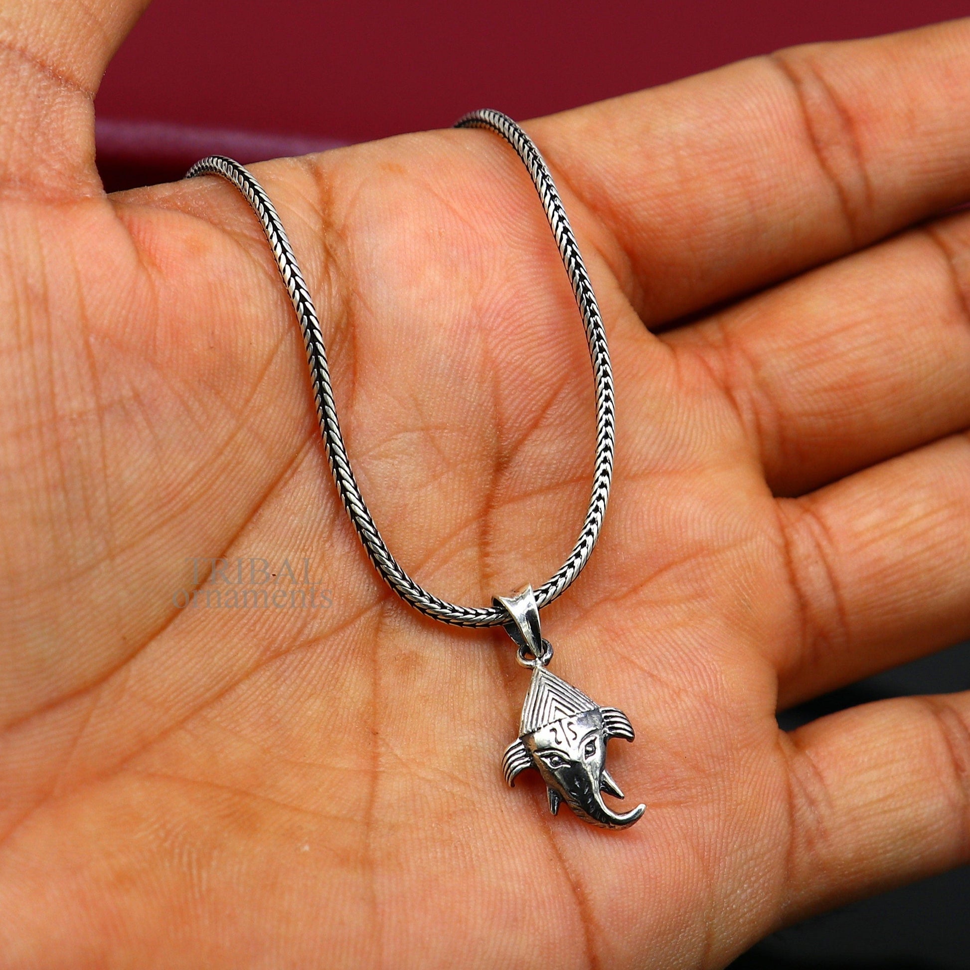 Sterling silver Lord Ganesha pendant by TRIBAL ORNAMENTS, unisex personalized jewelry with intricate design and stylish appearance.