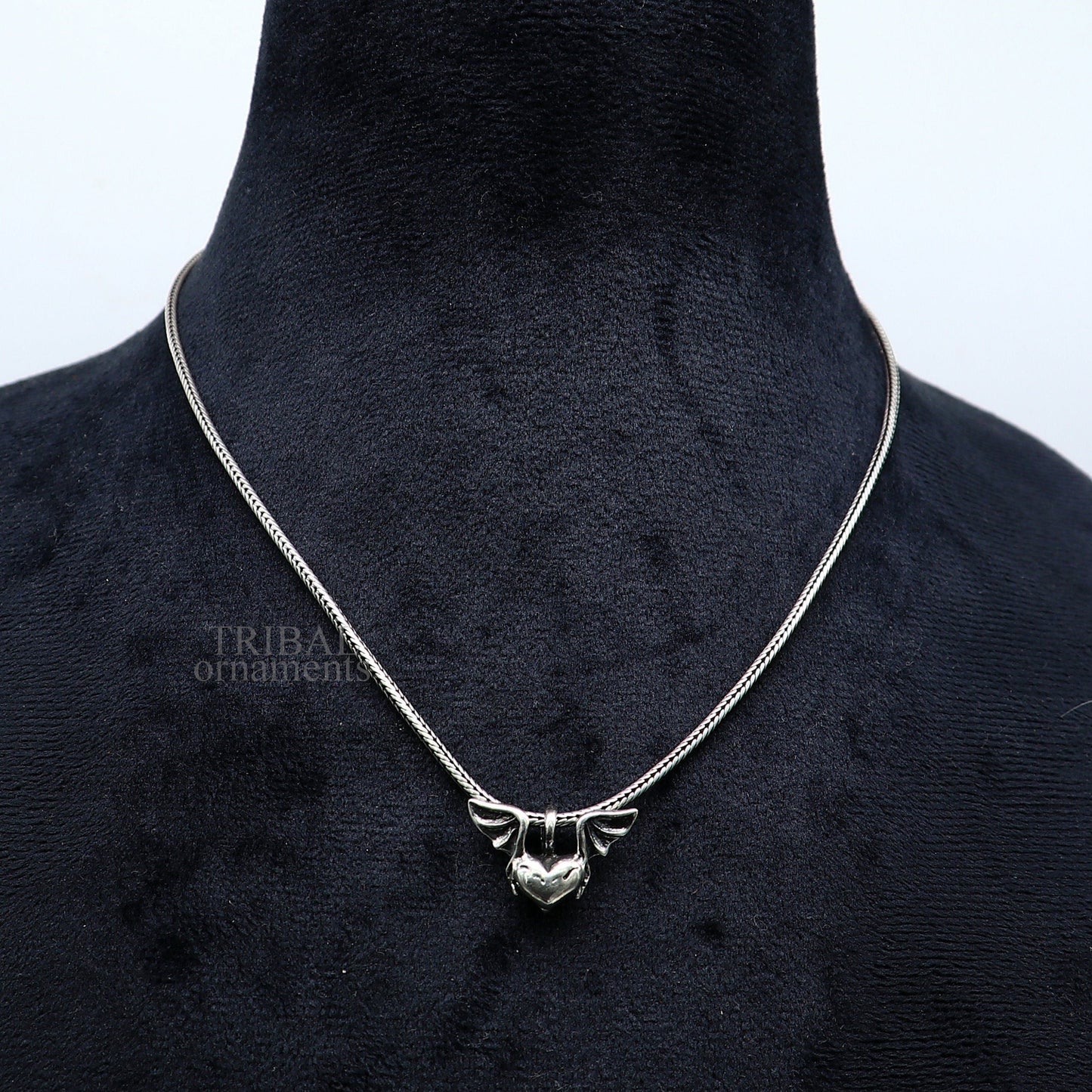 Sterling silver heart pendant with feather design, handmade unisex jewelry by Tribal Ornaments, stylish and perfect for gifting.