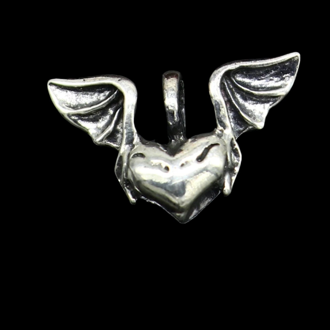 Sterling silver heart pendant with feather design by TRIBAL ORNAMENTS, stylish unisex jewelry with handmade craftsmanship.