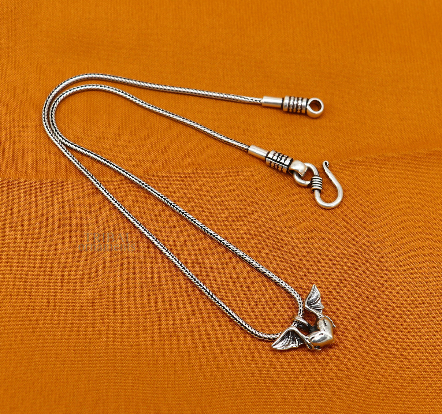 Sterling silver heart pendant with feather design, handmade unisex jewelry by Tribal Ornaments, stylish and perfect for gifting.