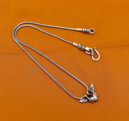 Sterling silver heart pendant with feather design, handmade unisex jewelry by Tribal Ornaments, stylish and perfect for gifting.
