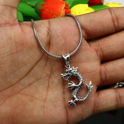 Sterling silver vintage dragon pendant by TRIBAL ORNAMENTS, stylish jewelry for boys and girls, featuring intricate tribal design.