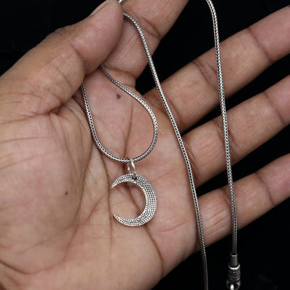 Sterling silver half moon pendant by TRIBAL ORNAMENTS, delicate silver jewelry for men and women, detailed moon design.