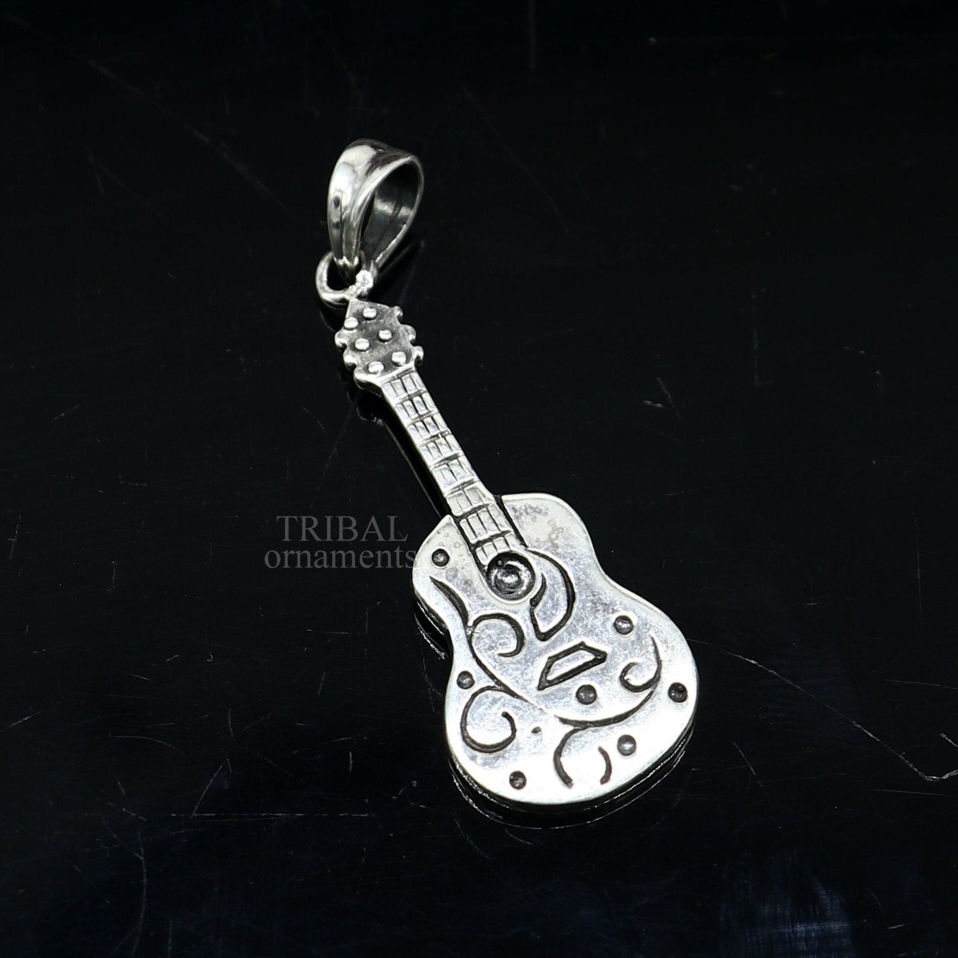 Sterling silver guitar design pendant by TRIBAL ORNAMENTS, unisex tribal jewelry, handmade, small and stylish guitar-shaped pendant.