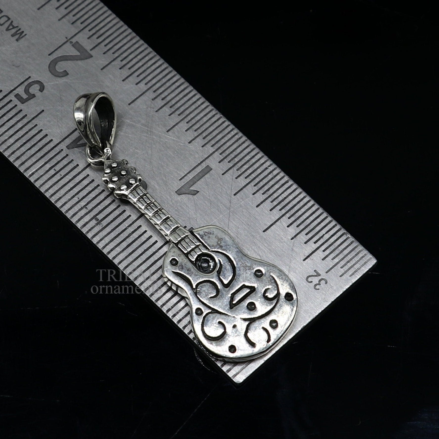 925 silver guitar design pendant by TRIBAL ORNAMENTS, handmade unisex jewelry with intricate tribal-inspired details.