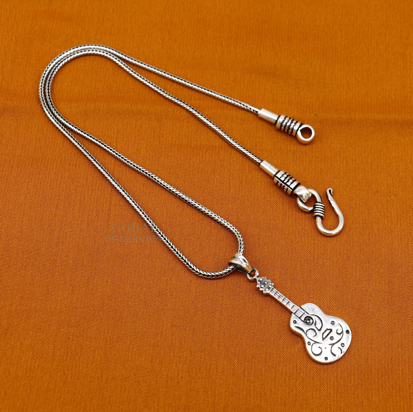 925 sterling silver guitar design pendant by Tribal Ornaments, unisex jewelry with a handmade tribal-inspired small guitar charm.