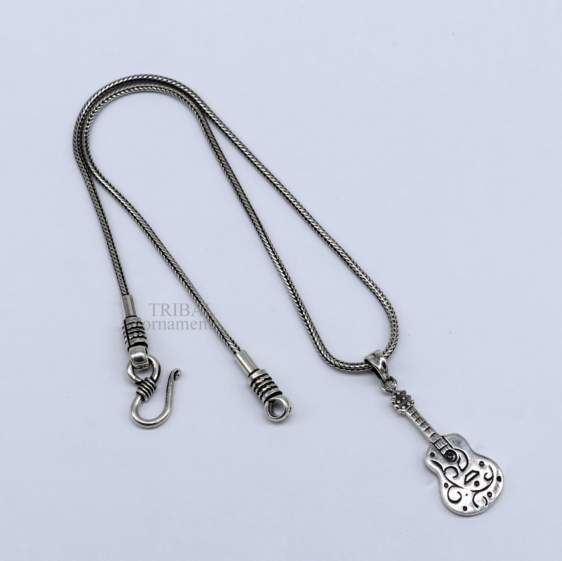 Sterling silver guitar design pendant by TRIBAL ORNAMENTS, unisex handmade tribal jewelry, stylish small guitar-shaped pendant.