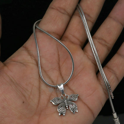 Sterling silver butterfly and bird pendant from Tribal Ornaments, handmade unisex jewelry with intricate design on a silver necklace.