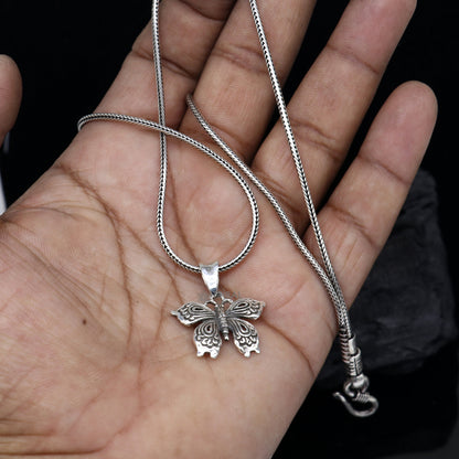 Sterling silver butterfly and bird pendant from Tribal Ornaments, handmade unisex jewelry, delicate silver necklace accessory.