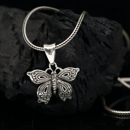 Sterling silver butterfly and bird pendant from TRIBAL ORNAMENTS, handmade unisex jewelry, delicate nature-inspired design.