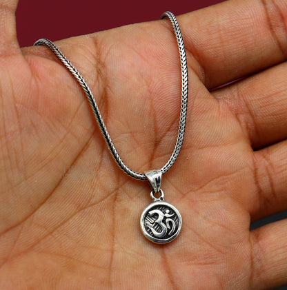925 sterling silver 'Aum' OM pendant from TRIBAL ORNAMENTS, showcasing intricate tribal design and divine good luck symbolism.