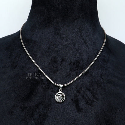 925 sterling silver 'Aum' OM pendant from TRIBAL ORNAMENTS, handmade divine jewelry with intricate tribal design and good luck symbolism.