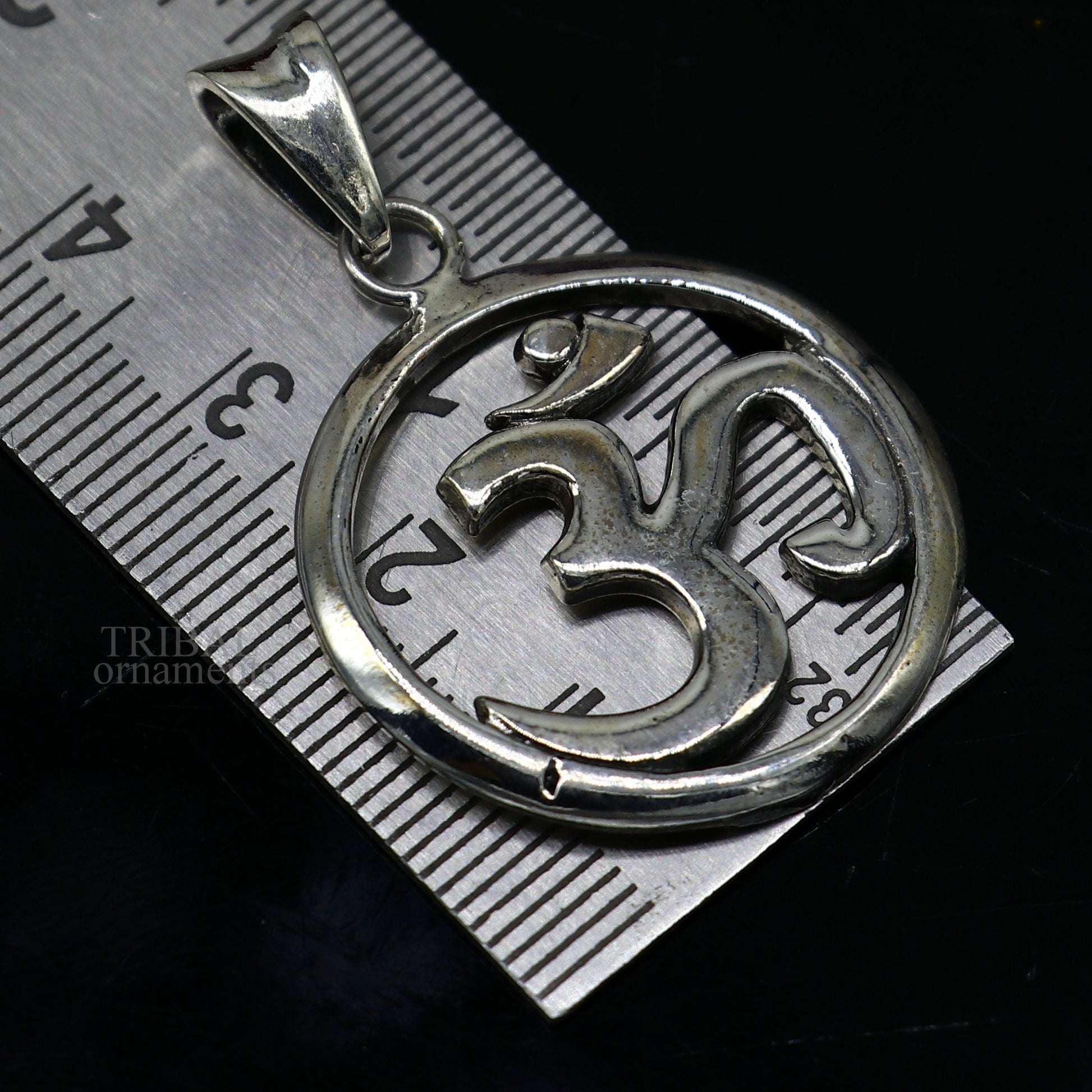 Sterling silver Hindu mantra Aum OM pendant by TRIBAL ORNAMENTS, featuring intricate tribal design and personalized good luck symbolism.