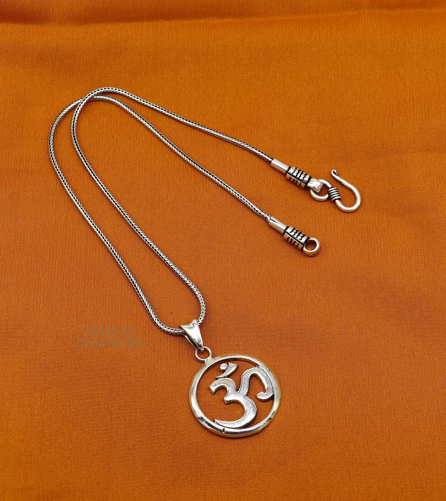 Sterling silver mantra 'Aum' OM pendant by TRIBAL ORNAMENTS, handmade Hindu jewelry with good luck symbolism.