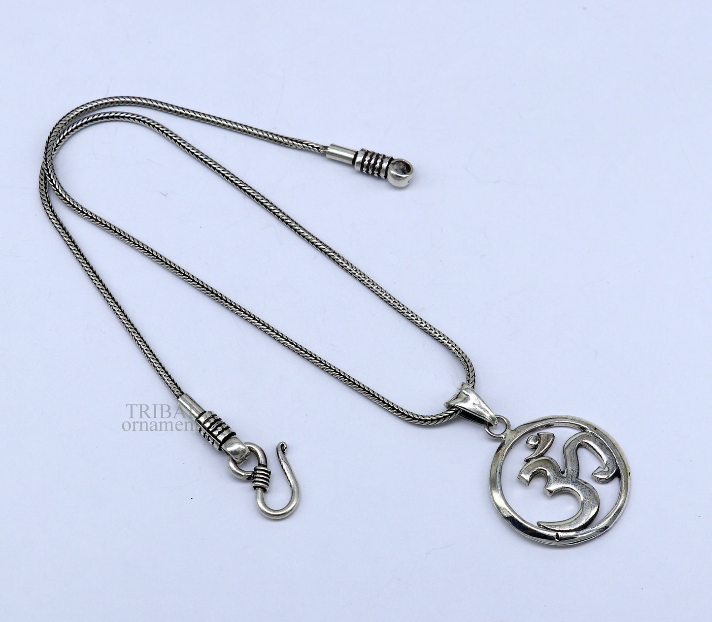 Sterling silver Hindu mantra Aum OM pendant by TRIBAL ORNAMENTS, featuring intricate tribal design and personalized good luck symbol.