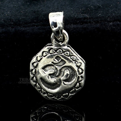 Sterling silver Hindu mantra 'Aum' OM pendant by TRIBAL ORNAMENTS, handmade tribal jewelry with good luck charm.