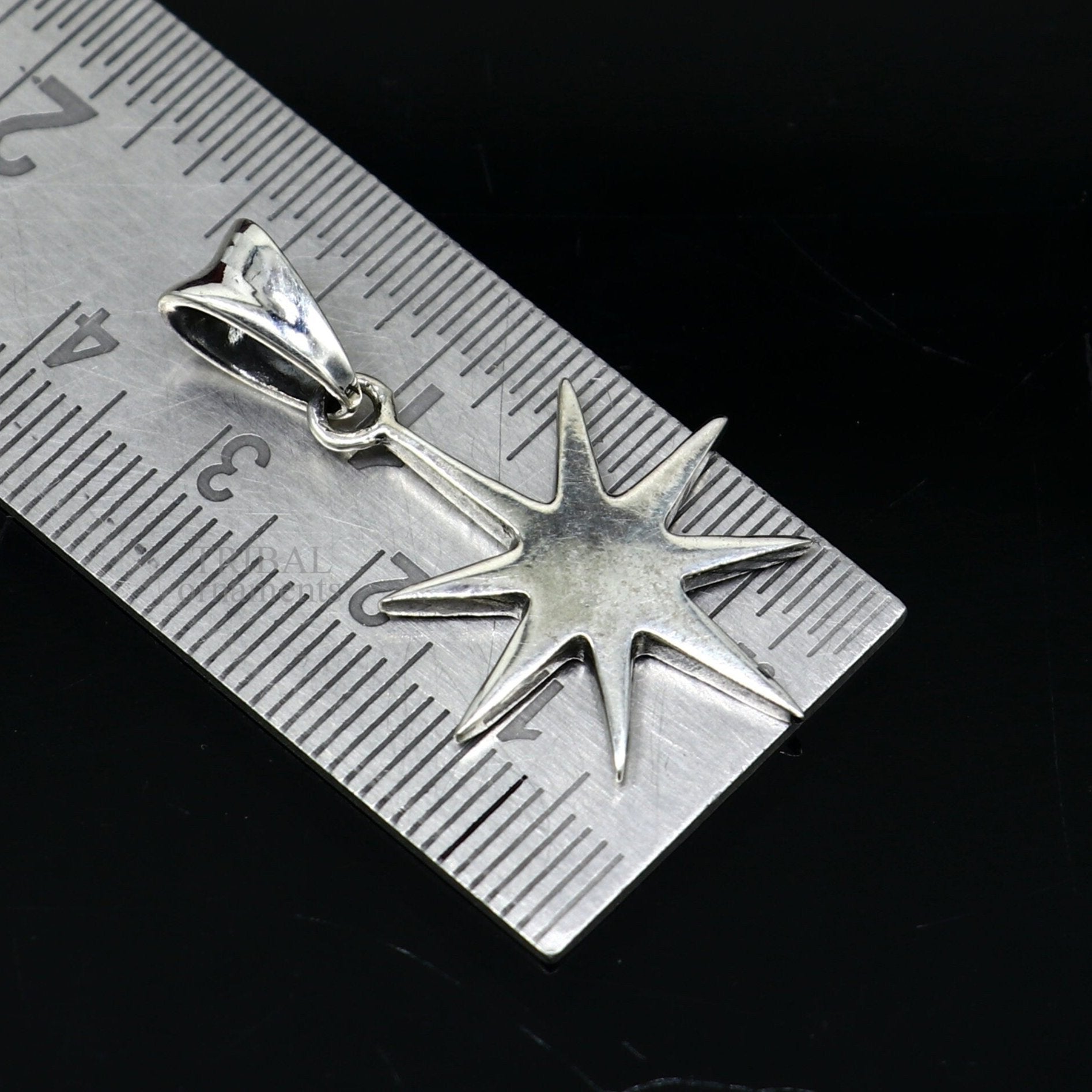 Elegant 925 sterling silver star pendant by TRIBAL ORNAMENTS, unisex handmade jewelry with a sleek, plain silver design.