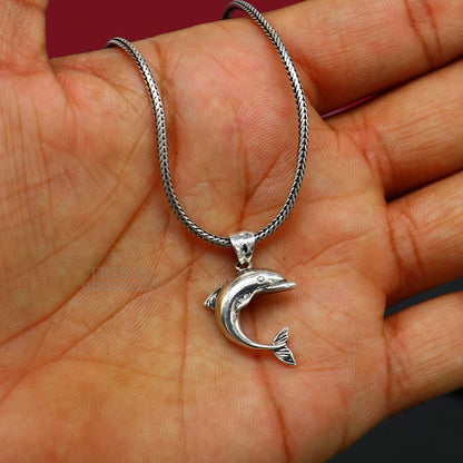 Sterling silver dolphin fish pendant by TRIBAL ORNAMENTS, handmade stylish jewelry, small dolphin design, perfect for gifting.