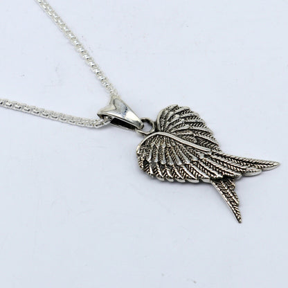 Sterling silver bird wing pendant from TRIBAL ORNAMENTS featuring a detailed feather design, ideal for animal jewelry enthusiasts.