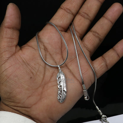Sterling silver bird wing pendant by TRIBAL ORNAMENTS, showcasing a detailed feather design in animal jewelry style.