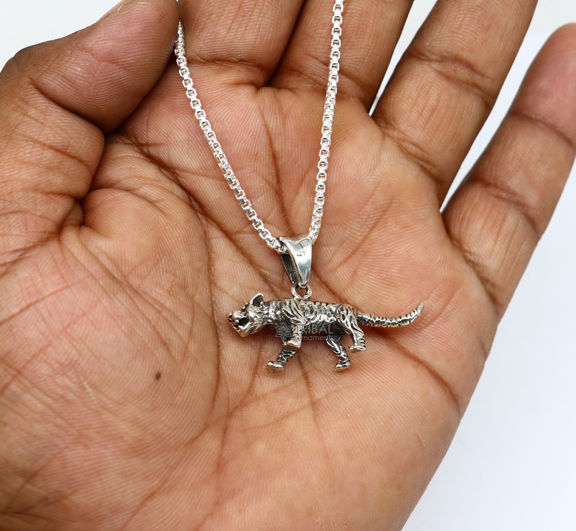 Sterling silver tiger and lion design pendant necklace by TRIBAL ORNAMENTS, unisex cultural jewelry with intricate details.