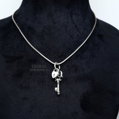 Sterling silver vintage style key and lock pendant by Tribal Ornaments, featuring intricate handmade design for boys and girls.