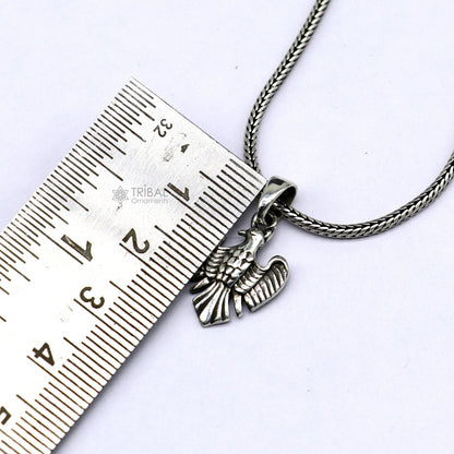 Sterling silver bird pendant by TRIBAL ORNAMENTS, featuring a dove design symbolizing peace, love, and purity.