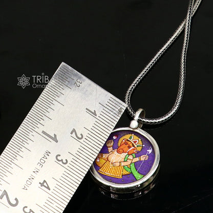 Sterling silver Ganesha pendant by TRIBAL ORNAMENTS, handmade idol jewelry with intricate painting, unisex gifting accessory.