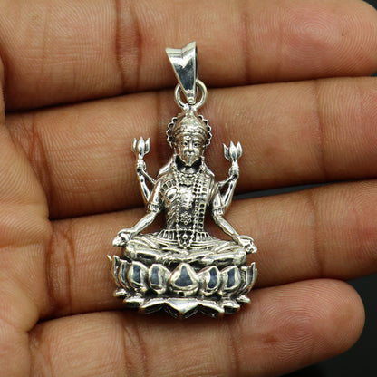 Handmade 925 sterling silver Goddess Mahalaxmi pendant from Tribal Ornaments, unisex Hindu jewelry, detailed designer craftsmanship.