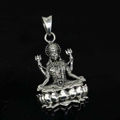 Sterling silver goddess Mahalaxmi pendant by TRIBAL ORNAMENTS, handcrafted unisex Hindu jewelry with intricate design.