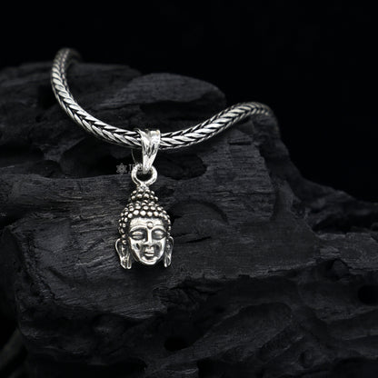 925 silver Lord Buddha face pendant by TRIBAL ORNAMENTS, close-up of detailed Buddha face jewelry symbolizing inner peace and wisdom.