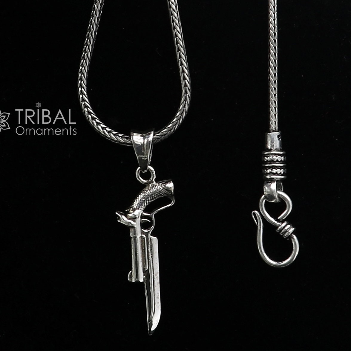 Sterling silver gun pendant by Tribal Ornaments, unisex revolver jewelry featuring detailed design for stylish gifting.