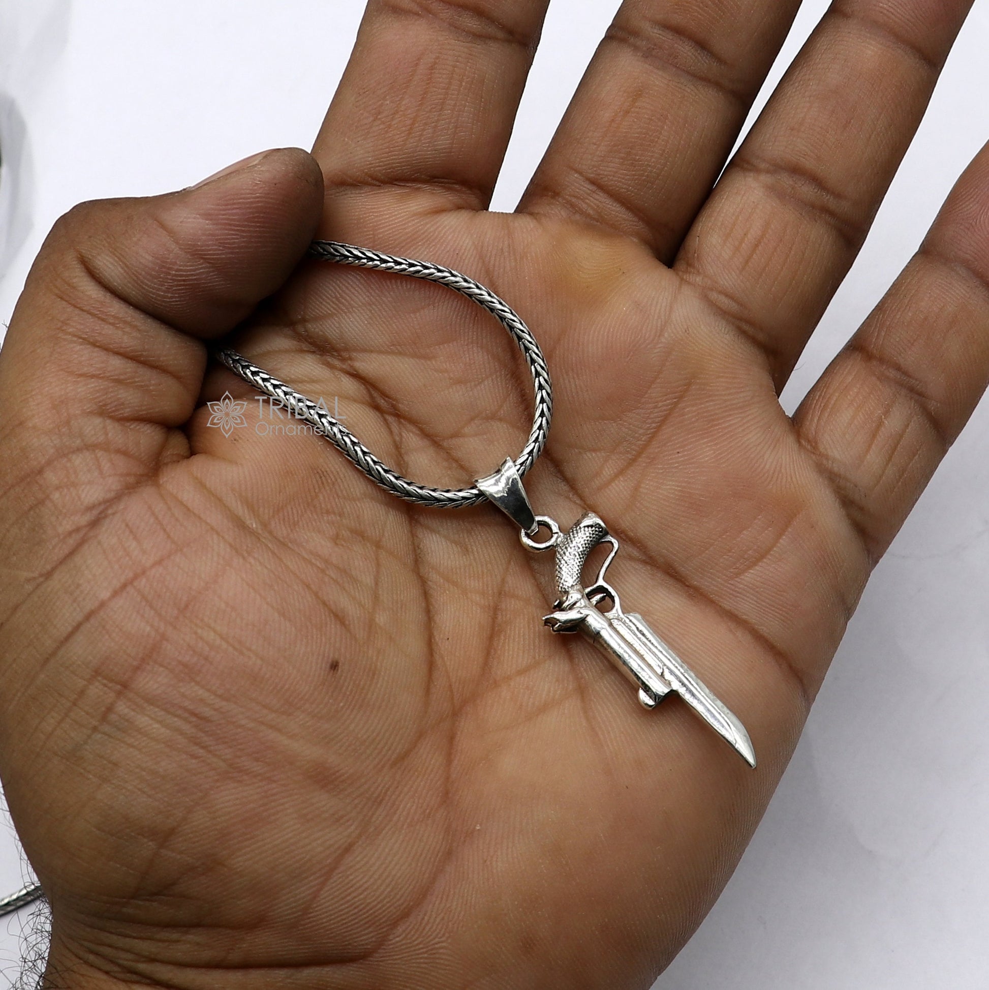 Sterling silver gun pendant by Tribal Ornaments, unisex revolver jewelry, detailed and stylish silver pistol necklace accessory.