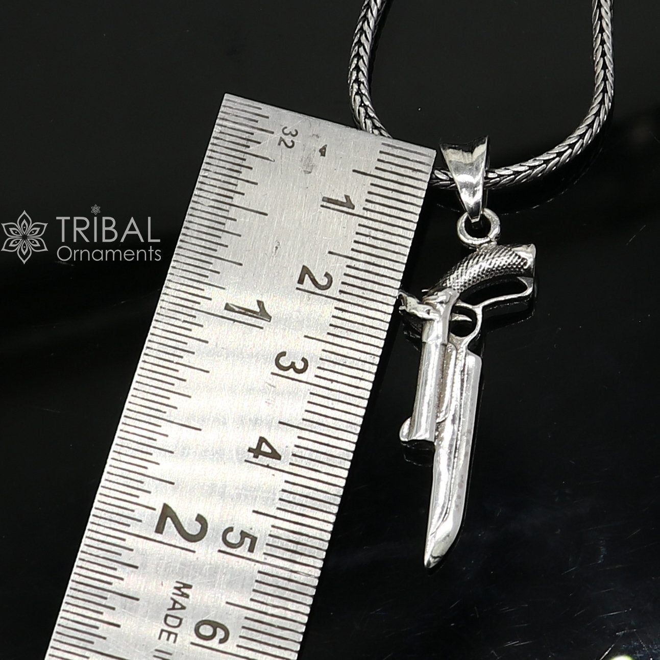 Sterling silver gun pendant by Tribal Ornaments, unisex revolver jewelry, stylish and unique silver pistol necklace accessory.