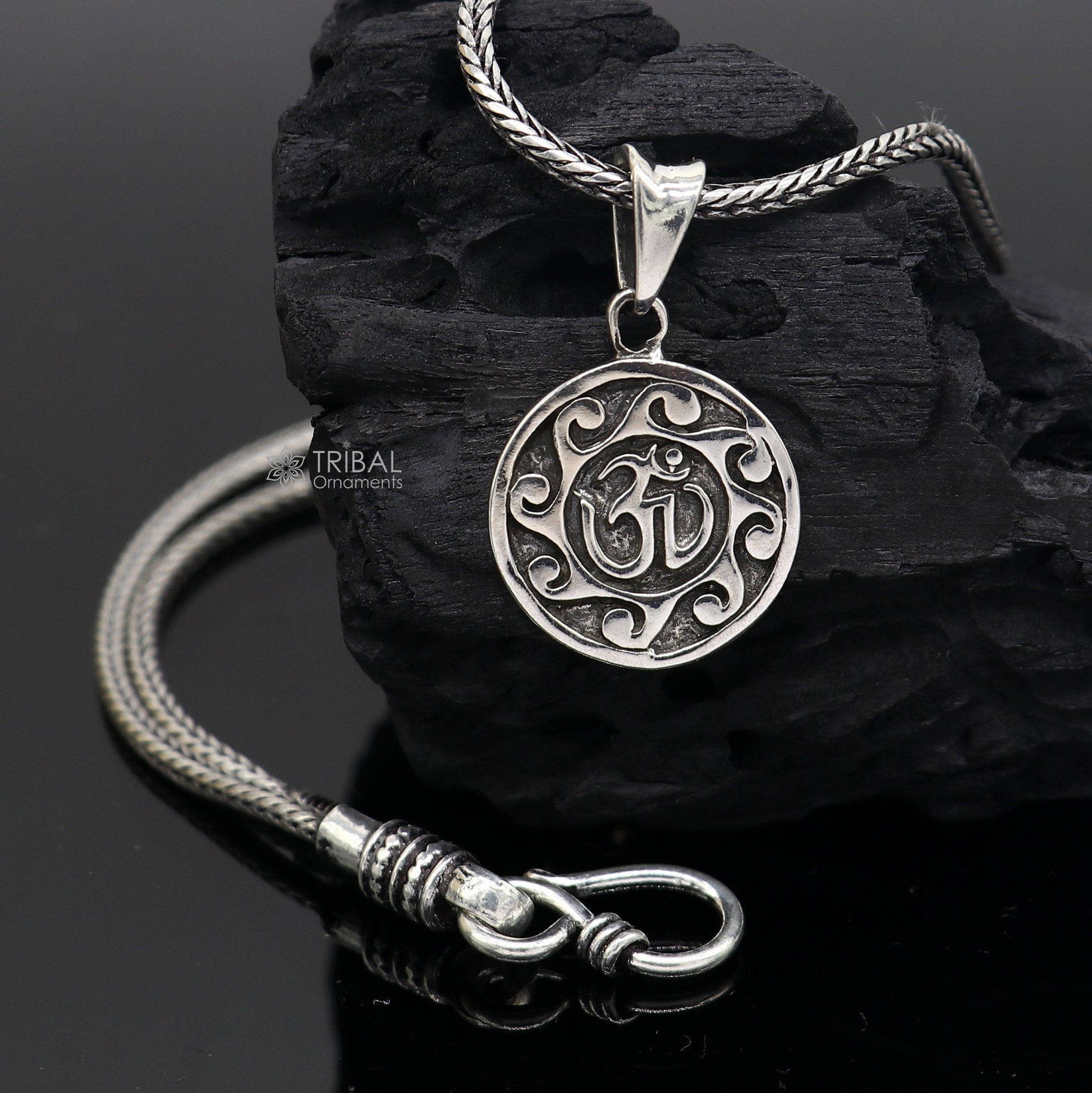 Sterling silver Divine 'Aum' OM pendant from TRIBAL ORNAMENTS, handmade tribal jewelry with good luck symbol and intricate design.
