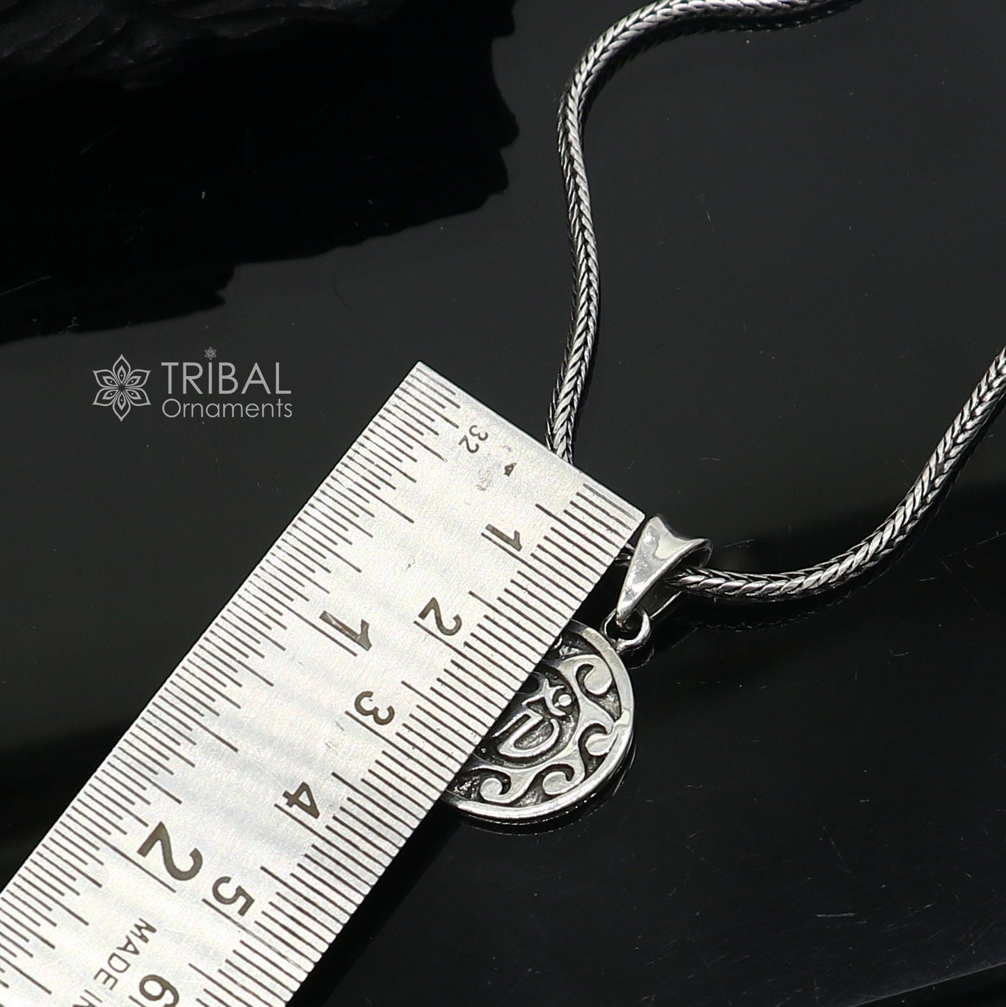 Sterling silver Divine Aum OM pendant from TRIBAL ORNAMENTS, handmade tribal jewelry with good luck symbolism and intricate tribal design.