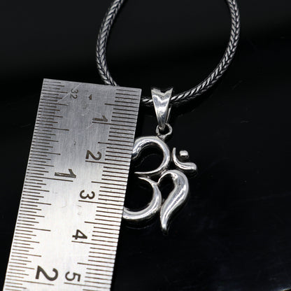 Sterling silver Divine 'Aum' OM pendant by TRIBAL ORNAMENTS, handmade tribal jewelry with intricate design and good luck symbolism.
