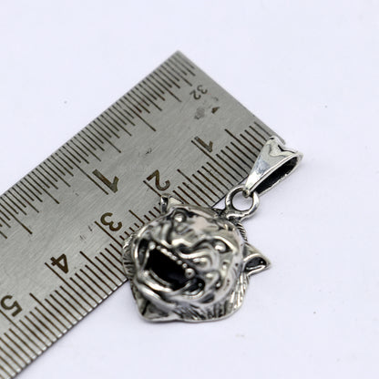 Sterling silver lion face pendant by TRIBAL ORNAMENTS, symbolizing courage, strength, and leadership in detailed craftsmanship.