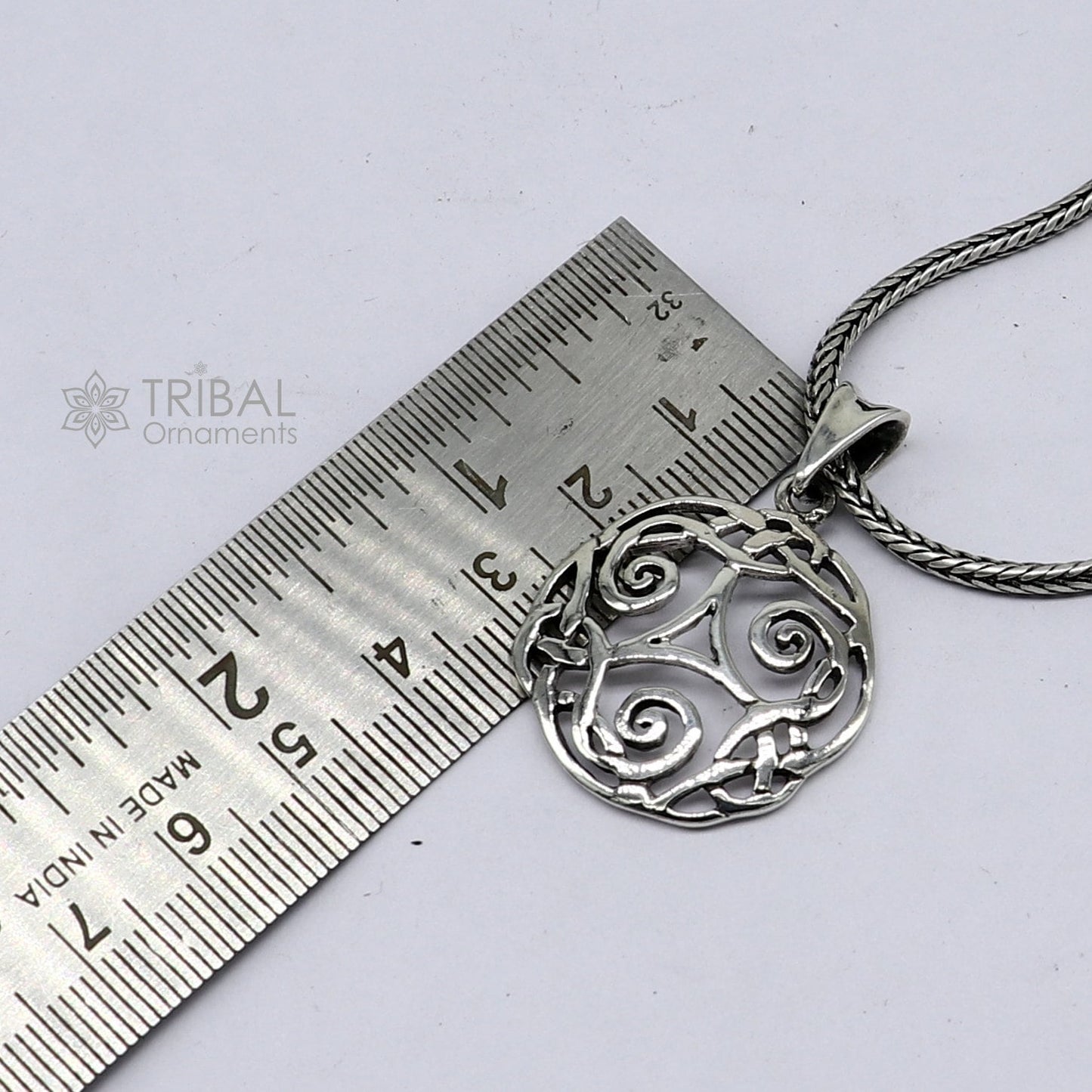 Sterling silver Triskelion Celtic pendant from Tribal Ornaments, featuring a detailed, stylish jewelry design on a silver necklace.