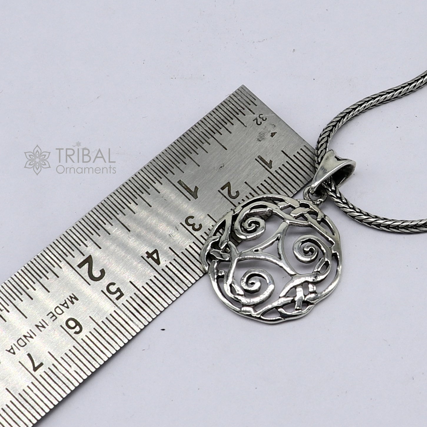 Sterling silver Triskelion Celtic pendant from Tribal Ornaments, featuring a detailed, stylish jewelry design on a silver necklace.