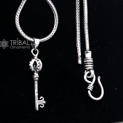 Sterling silver good luck key pendant on wheat chain necklace by TRIBAL ORNAMENTS, featuring a unique design and locket style.