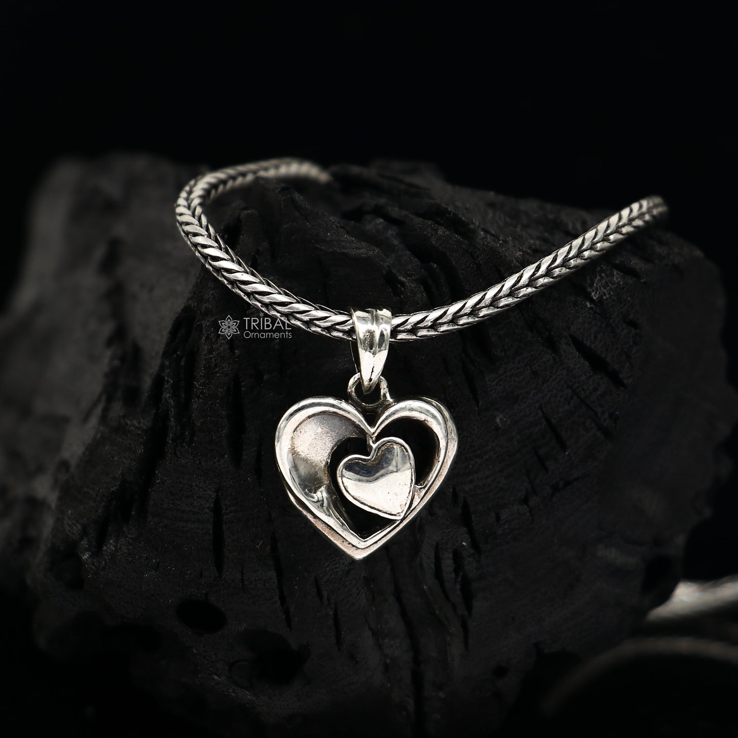 Sterling silver heart pendant necklace by TRIBAL ORNAMENTS, unisex jewelry with a unique design, perfect for gifting.